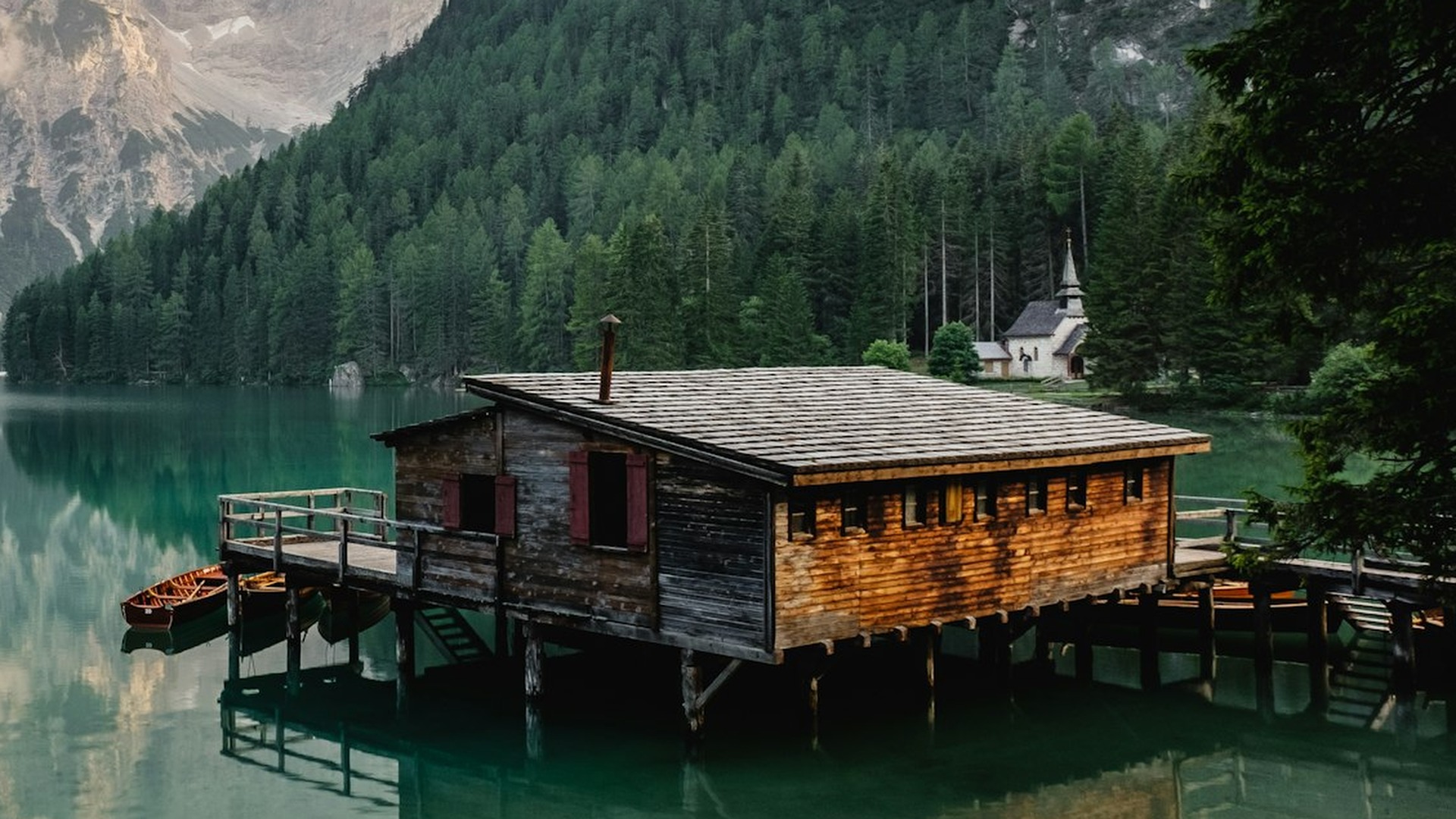 The same lake cabin moved onto the right third — the lake and church now have room to breathe.