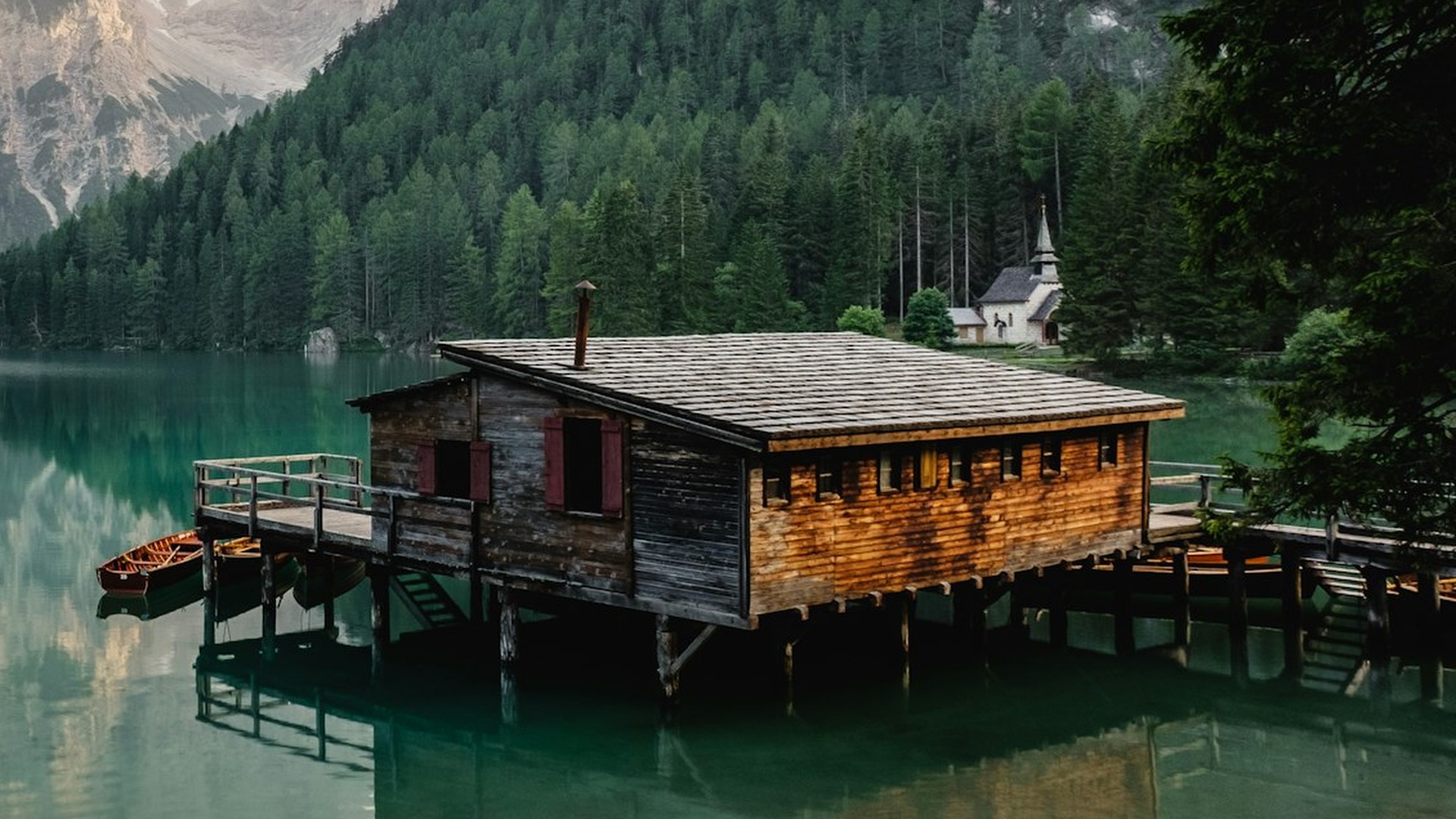 A lake cabin parked dead-center in the frame, crowding everything else out.