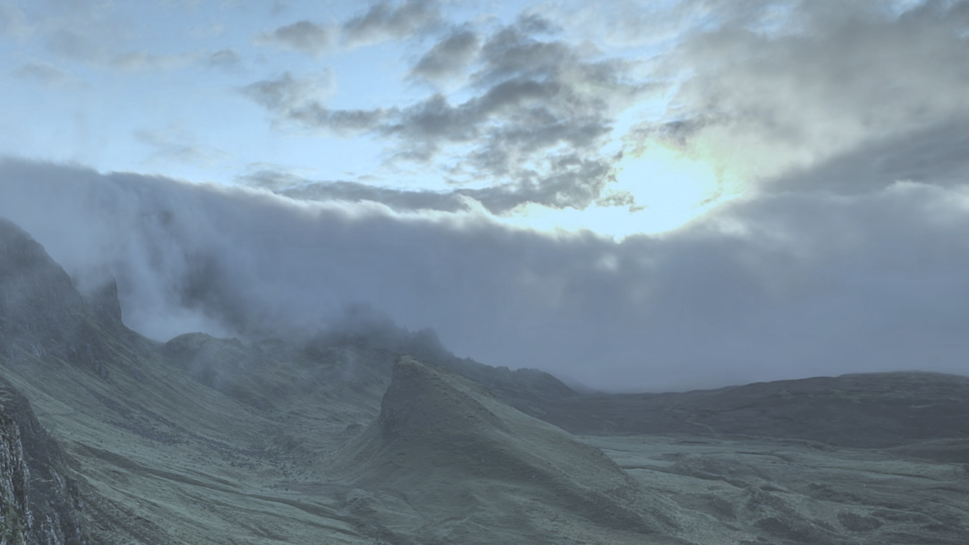 The same hills at harsh midday — flat, gray light.